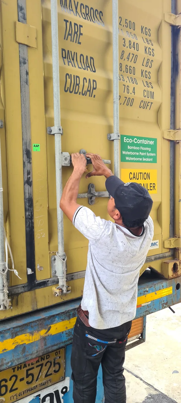Shipping container being secured for departure